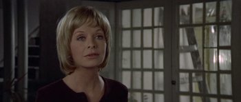 Movie still from “Images” (1972), directed by Robert Altman – A person with short blonde hair; Close Up shot, Over the shoulder angle