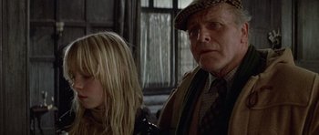A man and a woman sitting next to each other in front of a window