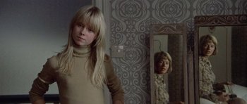 Movie still from “Images” (1972), directed by Robert Altman – A young girl standing in front of a bathroom mirror; Medium shot, Over the shoulder angle