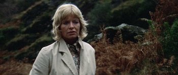 Movie still from “Images” (1972), directed by Robert Altman – A woman with blonde hair wearing a white jacket; Close Up shot, Low angle