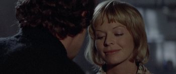 Movie still from “Images” (1972), directed by Robert Altman – A man and a woman face to face in a dark room; Close Up shot, Over the shoulder angle