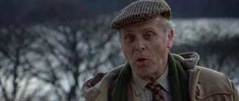 Movie still from “Images” (1972), directed by Robert Altman – An older man wearing a hat and a scarf; Close Up shot, Low angle