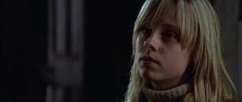 Movie still from “Images” (1972), directed by Robert Altman – A young blonde girl with long blonde hair wearing a sweater; Close Up shot, Low angle