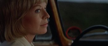 Movie still from “Images” (1972), directed by Robert Altman – A person sitting in a car; Close Up shot, Low angle