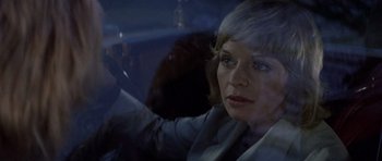 Movie still from “Images” (1972), directed by Robert Altman – A woman sitting in a car looking at the camera; Close Up shot, Over the shoulder angle