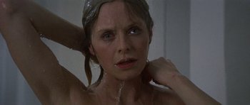 Movie still from “Images” (1972), directed by Robert Altman – A person taking a shower in a room; Close Up shot, Low angle