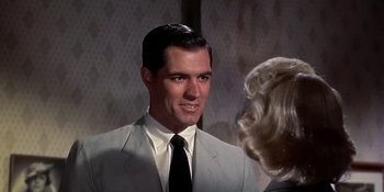 Movie still from “Imitation of Life” (1959), directed by Douglas Sirk – A man wearing a suit and tie talking to a woman; Close Up shot, Over the shoulder angle