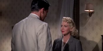 Movie still from “Imitation of Life” (1959), directed by Douglas Sirk – A man and a woman standing next to each other in a room; Medium shot, Over the shoulder angle