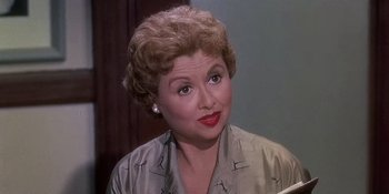 Movie still from “Imitation of Life” (1959), directed by Douglas Sirk – A person wearing a suit and tie; Close Up shot, Over the shoulder angle