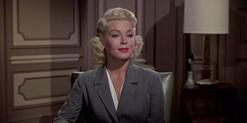 Movie still from “Imitation of Life” (1959), directed by Douglas Sirk – A woman with blonde hair sitting in a chair; Close Up shot, Low angle