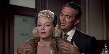 Movie still from “Imitation of Life” (1959), directed by Douglas Sirk – A man and a woman are standing next to each other; Close Up shot, Low angle