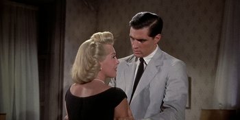 Movie still from “Imitation of Life” (1959), directed by Douglas Sirk – A man and a woman standing next to each other; Medium shot, Over the shoulder angle