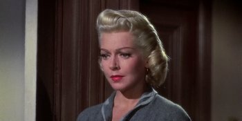 Movie still from “Imitation of Life” (1959), directed by Douglas Sirk – A woman with blonde hair is looking to her left; Close Up shot, Low angle