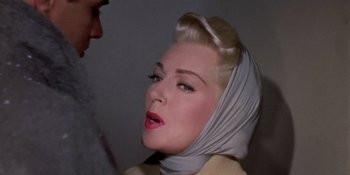 Movie still from “Imitation of Life” (1959), directed by Douglas Sirk – A woman wearing a head scarf with a man standing next to her; Close Up shot, Over the shoulder angle