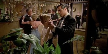 Movie still from “Imitation of Life” (1959), directed by Douglas Sirk – A man and a woman dancing in formal wear; Medium shot, Low angle