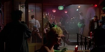 Movie still from “Imitation of Life” (1959), directed by Douglas Sirk – A group of people in a room at a party; Wide shot, Over the shoulder angle