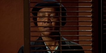 Movie still from “Imitation of Life” (1959), directed by Douglas Sirk – A man in a black hat looking through a window; Close Up shot, Low angle