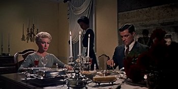 Movie still from “Imitation of Life” (1959), directed by Douglas Sirk – A man and a woman sitting at a dinner table; Medium shot, High angle