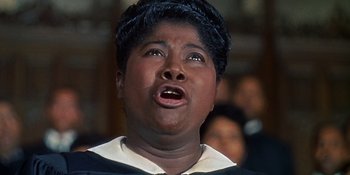 Movie still from “Imitation of Life” (1959), directed by Douglas Sirk – A woman with a surprised look on her face; Close Up shot, Low angle