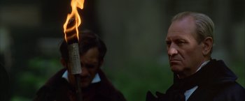 Movie still from “Immortal Beloved” (1994), directed by Bernard Rose – A man is holding a burning stick in front of him; Close Up shot, Low angle