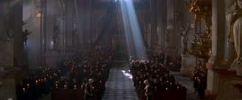 Movie still from “Immortal Beloved” (1994), directed by Bernard Rose – A group of people sitting in a room with candles; Extreme Wide shot, High angle