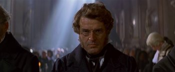Movie still from “Immortal Beloved” (1994), directed by Bernard Rose – A person wearing a suit and glasses; Close Up shot, Over the shoulder angle