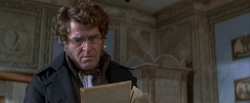 Movie still from “Immortal Beloved” (1994), directed by Bernard Rose – A man in glasses looking at a piece of paper; Close Up shot, Over the shoulder angle