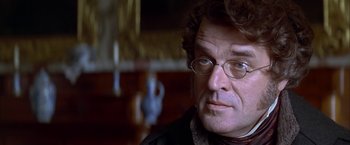 Movie still from “Immortal Beloved” (1994), directed by Bernard Rose – A person wearing glasses and a jacket; Close Up shot, Over the shoulder angle