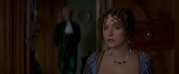 Movie still from “Immortal Beloved” (1994), directed by Bernard Rose – A person with curly hair wearing a necklace; Close Up shot, Over the shoulder angle