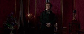 Movie still from “Immortal Beloved” (1994), directed by Bernard Rose – A man standing in front of candles in a dark room; Medium shot, Low angle