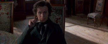 Movie still from “Immortal Beloved” (1994), directed by Bernard Rose – A man sitting in a chair in a room; Close Up shot, Over the shoulder angle