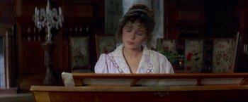 Movie still from “Immortal Beloved” (1994), directed by Bernard Rose – A woman in a purple shirt is playing the piano; Medium shot, High angle