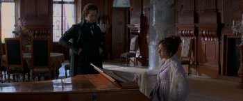 Movie still from “Immortal Beloved” (1994), directed by Bernard Rose – A man and a little girl standing next to a piano; Medium shot, High angle