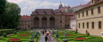 Movie still from “Immortal Beloved” (1994), directed by Bernard Rose – A group of people walking around a garden with statues; Extreme Wide shot, High angle