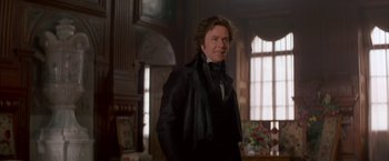 Movie still from “Immortal Beloved” (1994), directed by Bernard Rose – A man in a suit and tie standing in a room; Medium shot, Over the shoulder angle