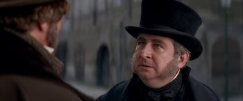 Movie still from “Immortal Beloved” (1994), directed by Bernard Rose – A man wearing a top hat and a bow tie; Close Up shot, Over the shoulder angle