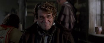 Movie still from “Immortal Beloved” (1994), directed by Bernard Rose – A person wearing glasses and a coat; Close Up shot, Over the shoulder angle