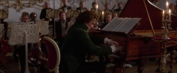 Movie still from “Immortal Beloved” (1994), directed by Bernard Rose – A man in a green jacket playing a piano; Medium shot, High angle
