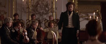 Movie still from “Immortal Beloved” (1994), directed by Bernard Rose – A group of people sitting in a room; Medium shot, Over the shoulder angle