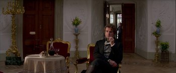 Movie still from “Immortal Beloved” (1994), directed by Bernard Rose – A man sitting on a chair in a room; Medium shot, Over the shoulder angle