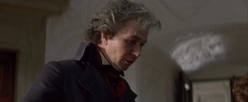 Movie still from “Immortal Beloved” (1994), directed by Bernard Rose – A person wearing a suit and tie; Close Up shot, Over the shoulder angle