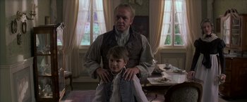 Movie still from “Immortal Beloved” (1994), directed by Bernard Rose – A man standing next to a young boy in a room; Medium shot, Low angle