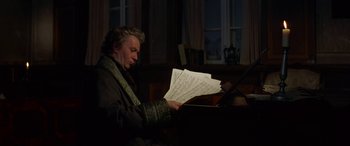 Movie still from “Immortal Beloved” (1994), directed by Bernard Rose – A man sitting at a piano looking at sheet music; Medium shot, Low angle