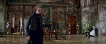 Movie still from “Immortal Beloved” (1994), directed by Bernard Rose – A man standing in front of a room with paintings on the walls; Medium shot, Over the shoulder angle