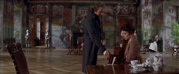 Movie still from “Immortal Beloved” (1994), directed by Bernard Rose – A man and a woman are standing in front of a table; Medium shot, Over the shoulder angle