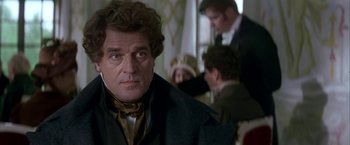 Movie still from “Immortal Beloved” (1994), directed by Bernard Rose – A person wearing a suit and tie; Close Up shot, Over the shoulder angle