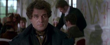 Movie still from “Immortal Beloved” (1994), directed by Bernard Rose – A person wearing a suit and tie; Close Up shot, Over the shoulder angle