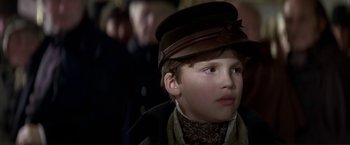 Movie still from “Immortal Beloved” (1994), directed by Bernard Rose – A young boy wearing a brown hat and a scarf; Close Up shot, Over the shoulder angle