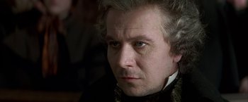 Movie still from “Immortal Beloved” (1994), directed by Bernard Rose – A person wearing a suit and tie; Close Up shot, Over the shoulder angle