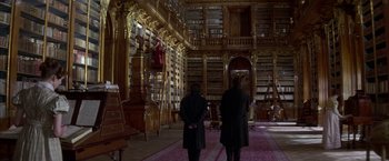 Movie still from “Immortal Beloved” (1994), directed by Bernard Rose – Two people standing in front of a large library; Wide shot, Low angle